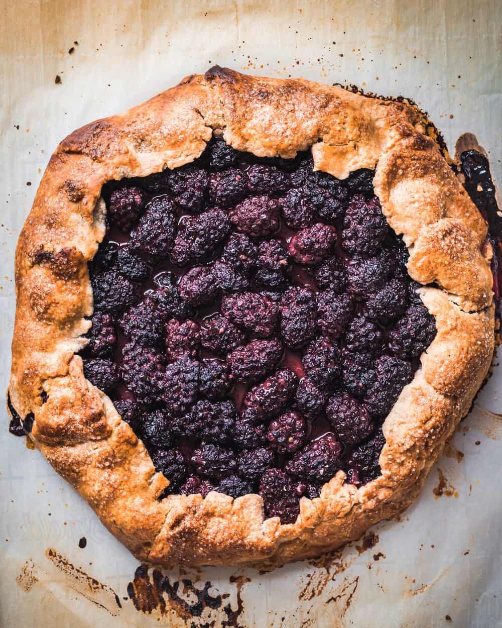 Cooked blackberry galette on a baking sheet.