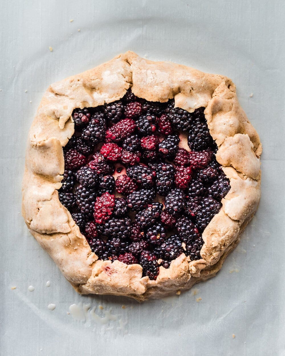 Galette dough folded over all sides of blackberries.