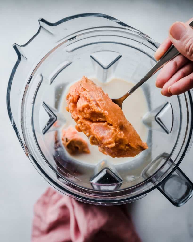 sweet potato being added to blender