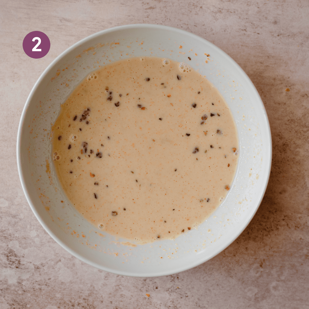 tahini and spices in a bowl with plant milk all mixed together.