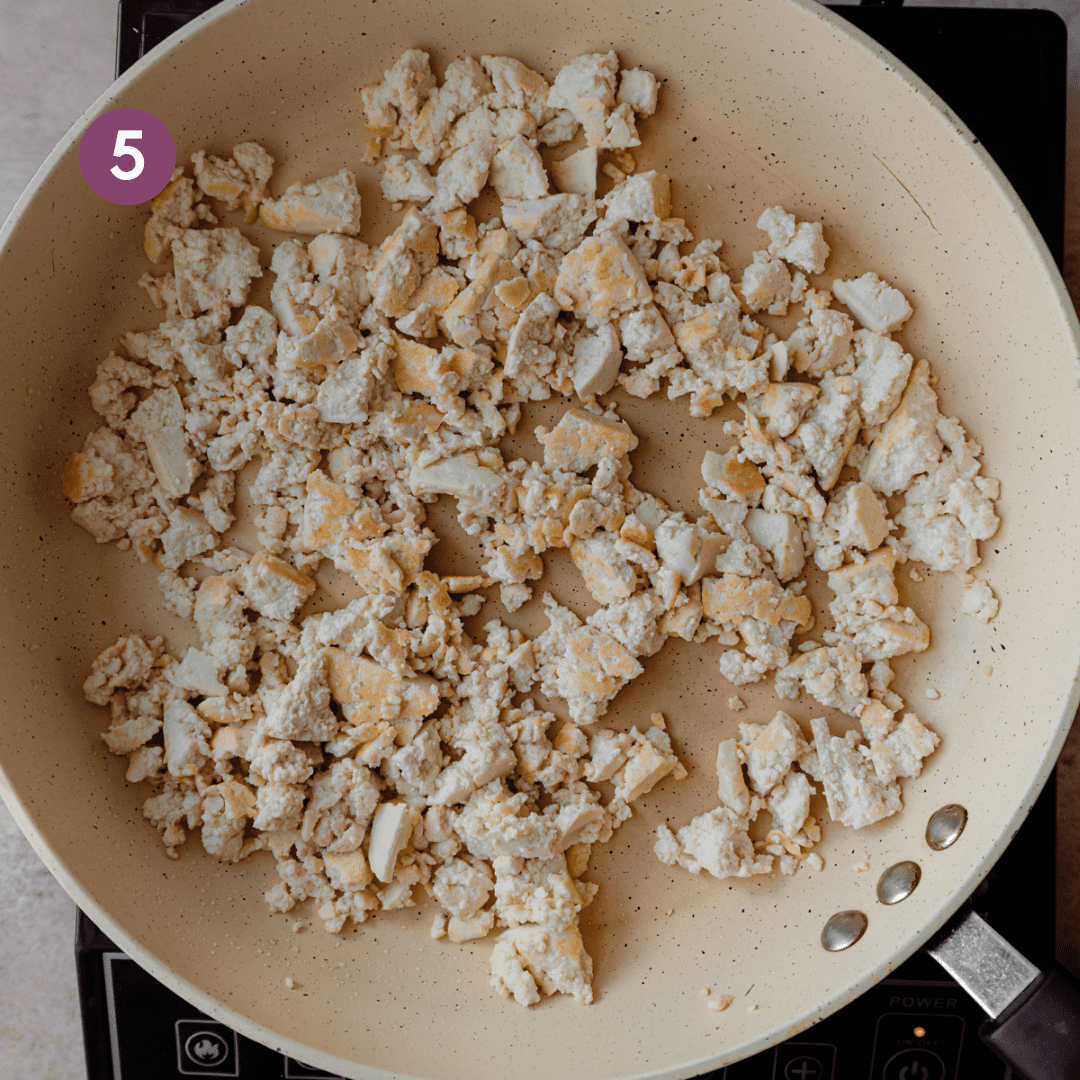 cooked tofu chunks in frying pan.