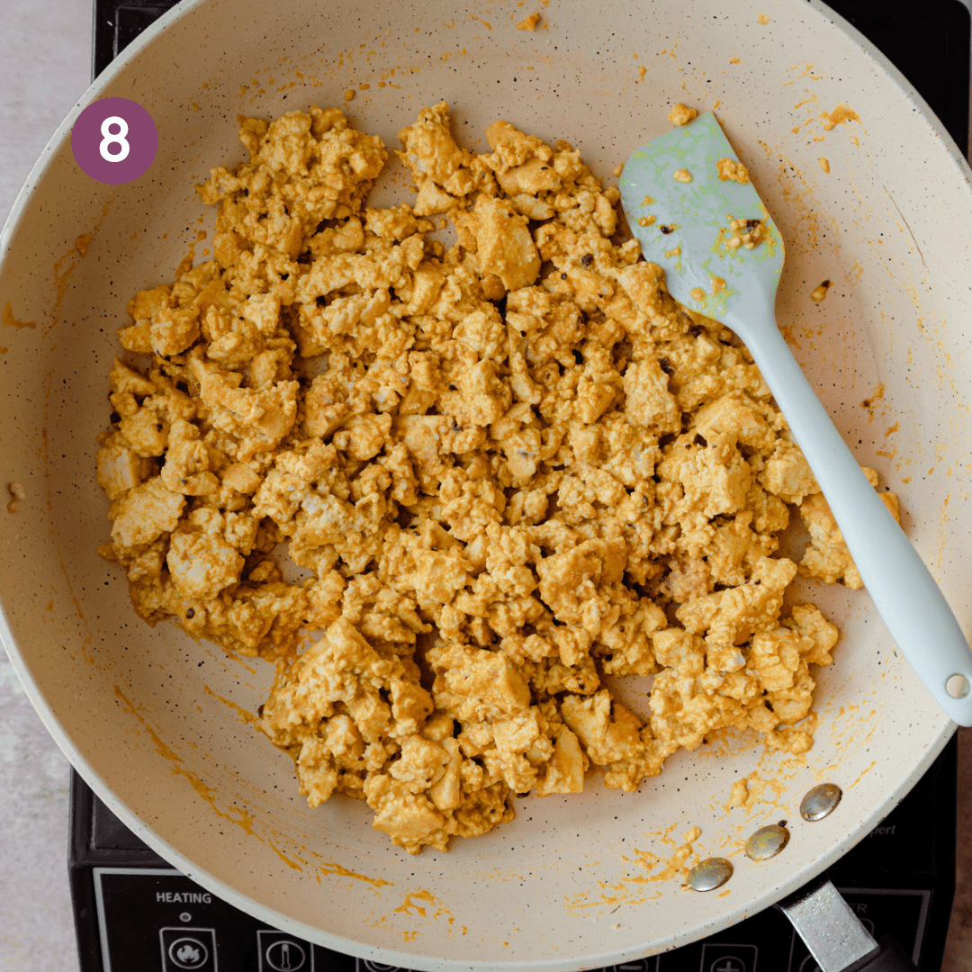 finished tofu scramble in frying pan with a silicone spatula.