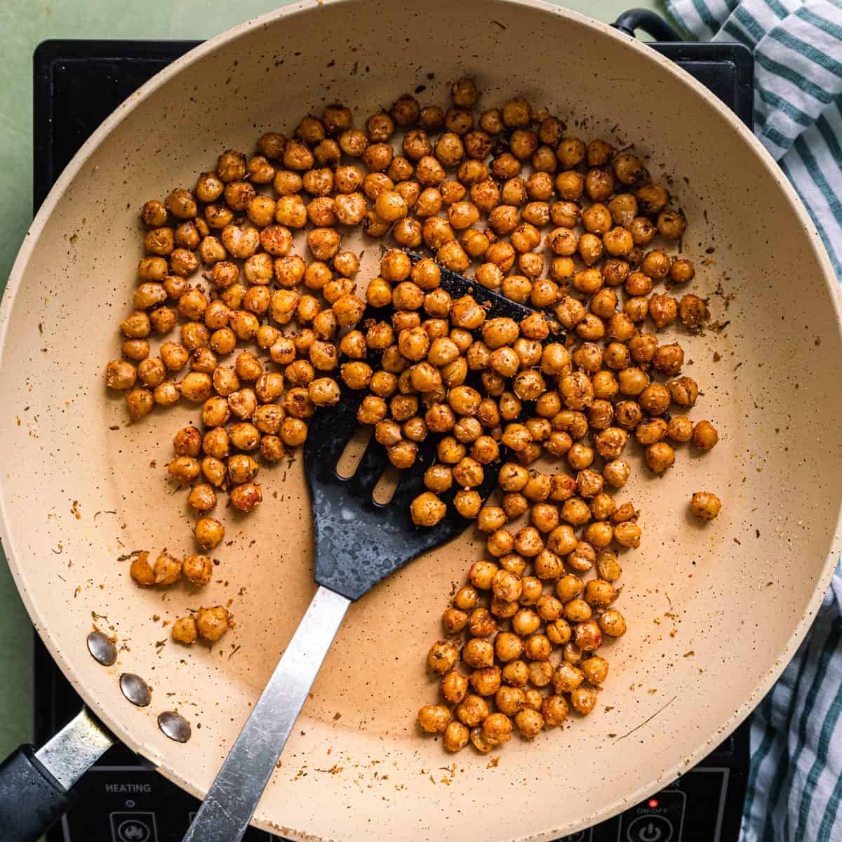 tossing pan-fried chickpeas in a saute pan.