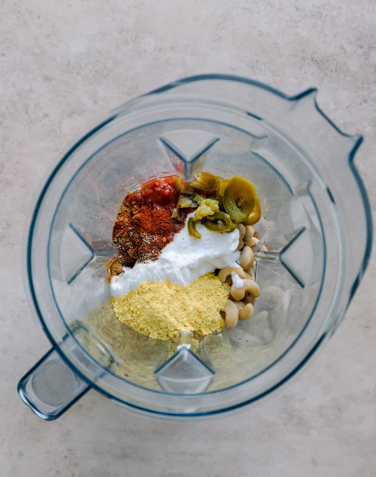 cashews, salsa, yogurt, spices, jalapeños/their brine, and nutritional yeast in a blender.