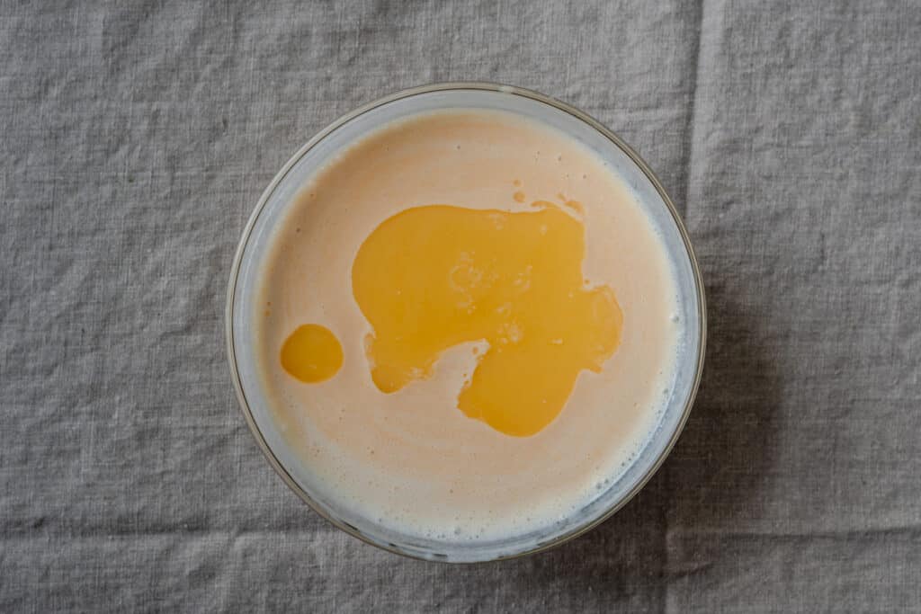 melted vegan butter in a bowl of buttermilk