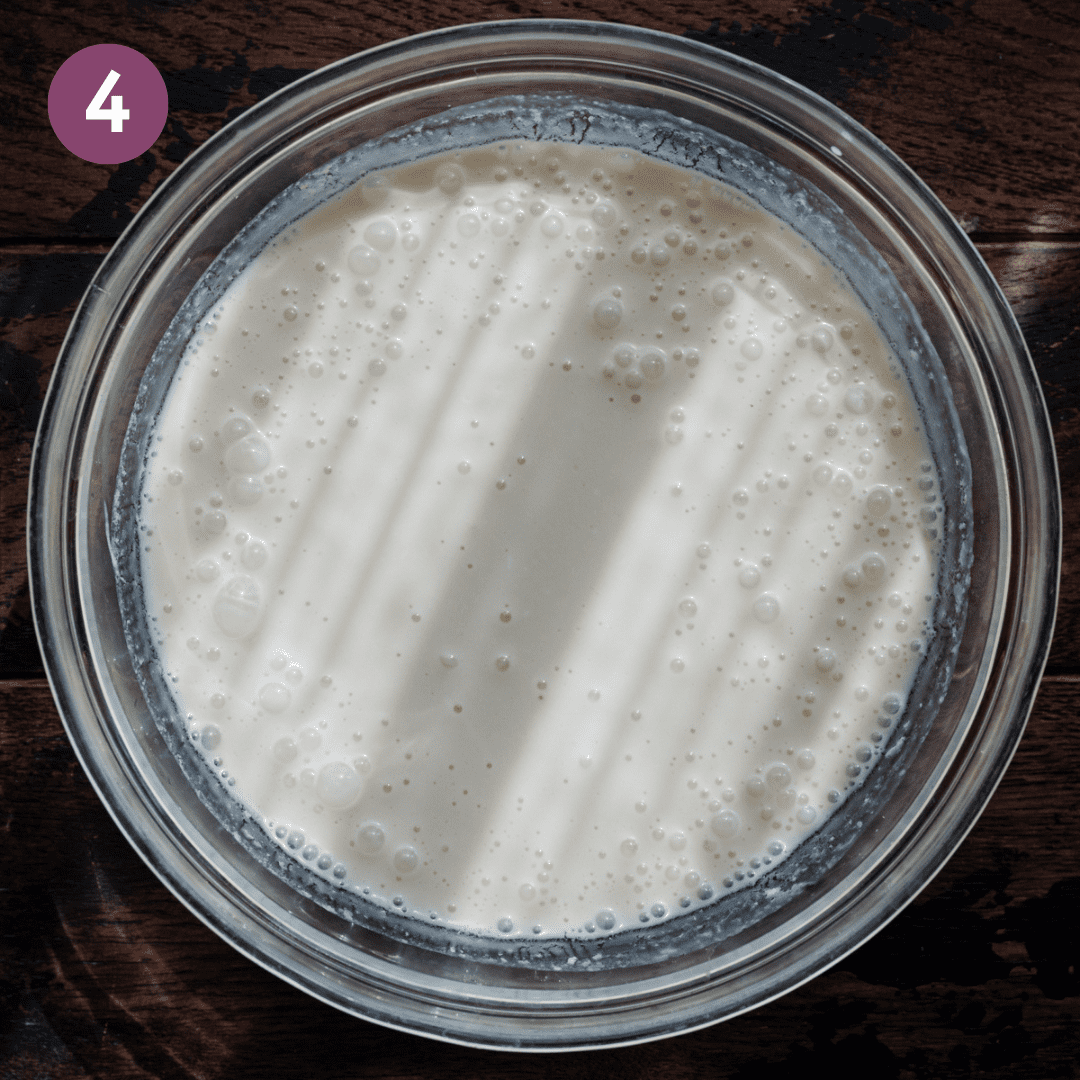 bubbly liquid ingredients in a glass bowl for vegan pancakes.