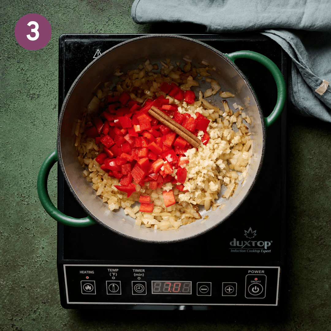 Garlic, bell pepper and cinnamon stick with the onions in the dutch oven.