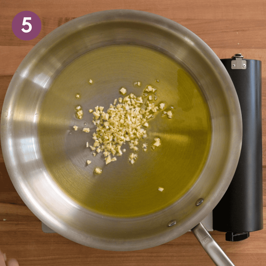 garlic and oil in a saute pan before being cooked.
