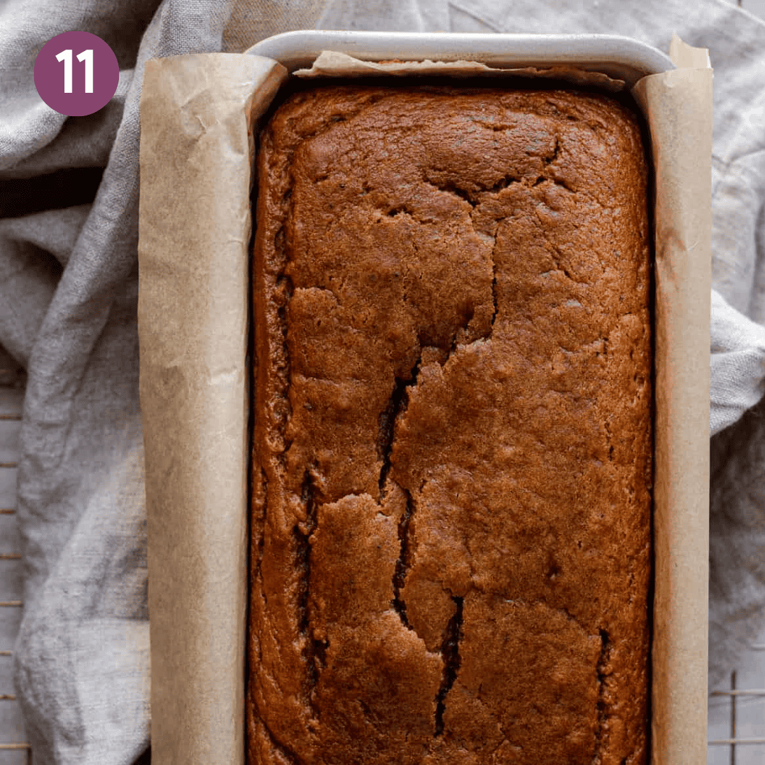 baked pumpkin bread in loaf pan on table with a linen napkin.